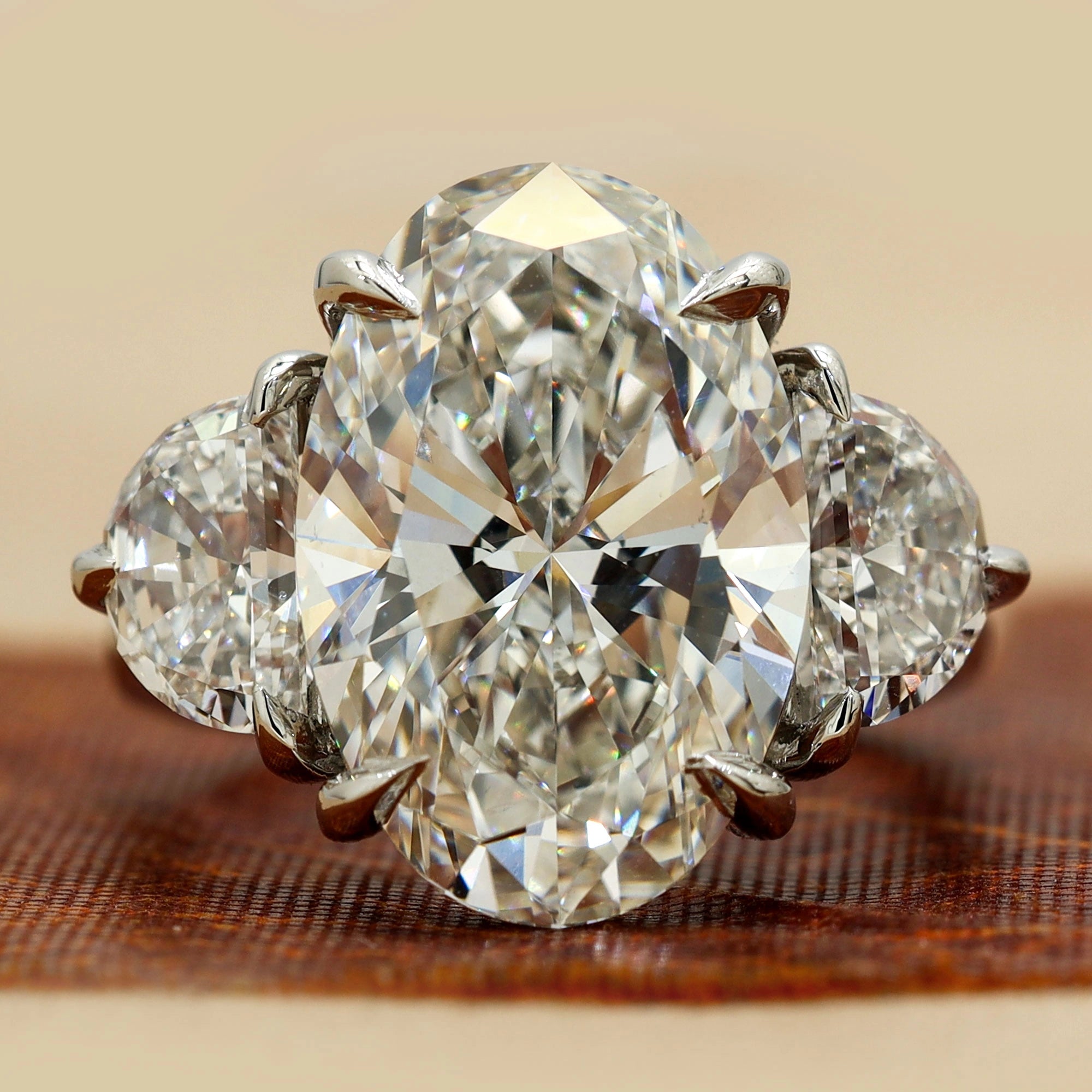 8.9 Oval Cut diamond engagement ring paired with half-moon cut 18K White Gold