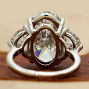 Back View Of 8.9 Oval Cut diamond engagement ring paired with half-moon cut