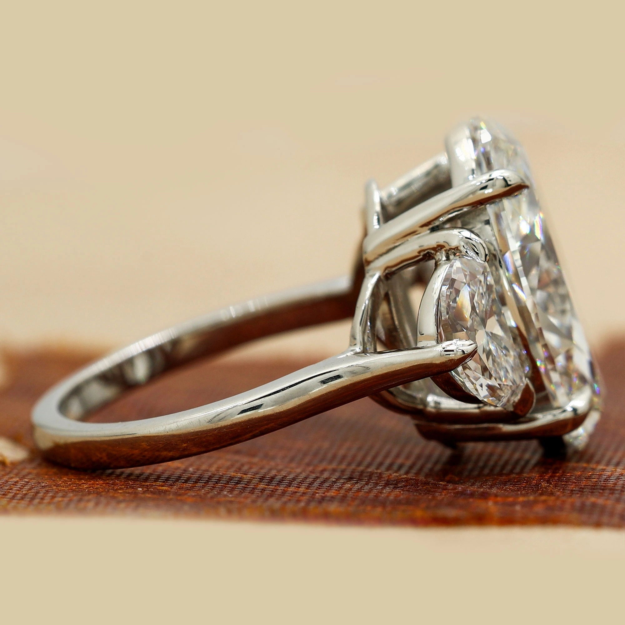 Side View Of 8.9 Oval Cut diamond engagement ring paired with half-moon cut